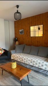 a living room with a couch and a coffee table at Appartement tt confort au coeur des montagnes vue sur les montagnes II Wifi in Luz-Saint-Sauveur