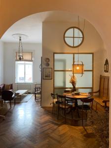 a dining room and living room with a table and chairs at ANNO 1800 in Bistriţa