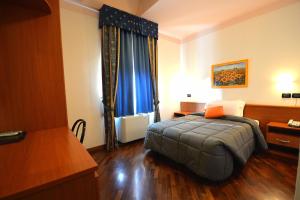 a hotel room with a bed and a window at Hotel La Cantina in Alfonsine