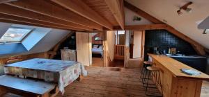 a room with a kitchen with a table and a sink at Loft des Cimes - Evasion en montagne avec local vélo privé in Cornimont