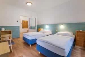 Ένα ή περισσότερα κρεβάτια σε δωμάτιο στο Sport Hotel Gejzirpark