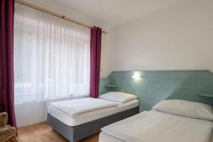Ένα ή περισσότερα κρεβάτια σε δωμάτιο στο Sport Hotel Gejzirpark