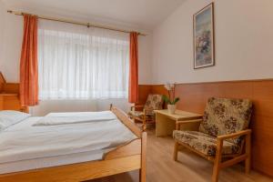 Ένα ή περισσότερα κρεβάτια σε δωμάτιο στο Sport Hotel Gejzirpark