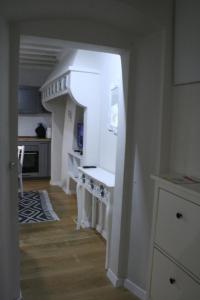 a kitchen with a white counter in a room at Allie's flat in Antella +2 photos