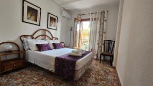 En eller flere senge i et værelse på Casa Valentino