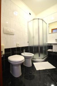a bathroom with a toilet and a shower at Hotel La Cantina in Alfonsine +32 photos