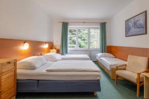 Ένα ή περισσότερα κρεβάτια σε δωμάτιο στο Sport Hotel Gejzirpark
