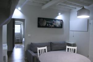 a living room with a couch and a table at Allie's flat in Antella