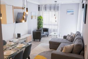 a living room with a couch and a table at Beach Apartment in Armação de Pêra
