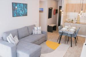 a living room with a couch and a table at Beach Apartment in Armação de Pêra