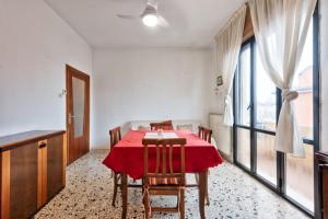 a dining room with a red table and chairs at Easy Old City Apt Venice in Venice