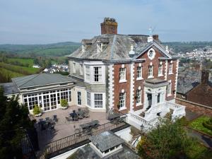 a large brick building with a clock on it at The Eagle House Hotel in Launceston