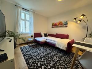 a room with a bed and a couch in it at MARKINA- Ferienwohnung "Am Park" in Mühlhausen