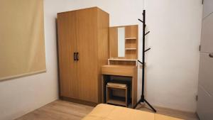 a room with a cabinet and a bed in a room at Minimal House at Kanchanadit in Ban Nong Suan