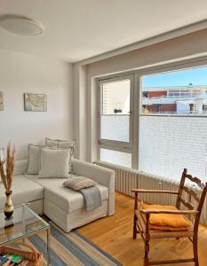 a living room with a couch and a window at Haus Grömitz Wohnung 15 in Grömitz
