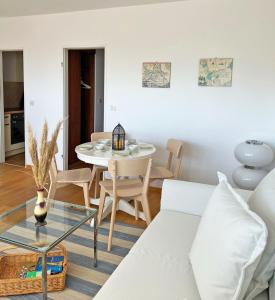 a living room with a white couch and a table at Haus Grömitz Wohnung 15 in Grömitz
