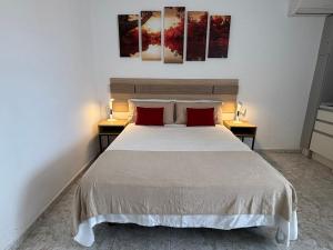 a bedroom with a large bed with two tables at Luceros 310 New in Alicante