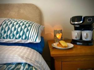 a plate of food on a table next to a bed at Brynmyrddin country living in Llandysul
