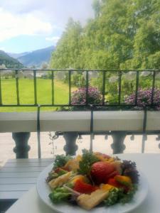 a plate of food on a table on a balcony at Petrines Gjestgiveri in Norddal +37 photos