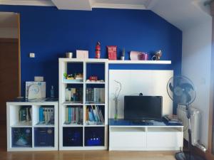 a white book shelf with a tv in a room at Cambados Apartamento VUT-PO-TU986D in Cambados