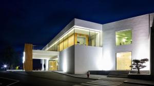 a large white building at night with lights at Hotel Minho in Vila Nova de Cerveira