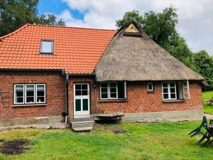 a red brick house with an orange roof at Haus Lieschen in Goosefeld