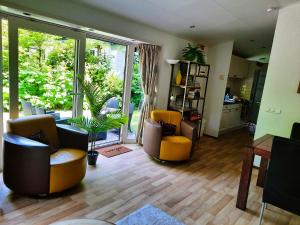 a living room with two chairs and a table at Veluwe Flow in Epe