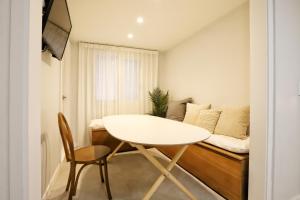 a small room with a white table and a couch at Malang Cozy Home in Seoul