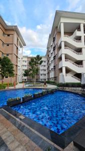 a swimming pool in front of a building at Andele's Place in Marilao