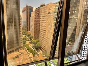a view of a city from a window at Refúgio carioca com piscina in Rio de Janeiro