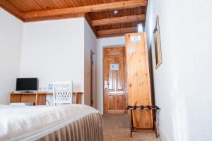 a bedroom with a bed and a wooden door at Hotel Caravan Serail in Samarkand