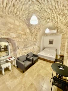 a room with a bed and a couch and a table at Christian Quarter Studio I in Jerusalem