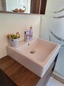a white sink in a bathroom next to a shower at Escape to Tranquility ! in Kiserian +14 photos