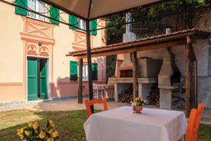a table and chairs in front of a building at La BRIGNA B&B Il bosco sul mare in Genoa