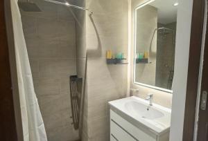 a bathroom with a sink and a shower with a mirror at Colombo Trizen J&J future Apart ment in Colombo +99 photos