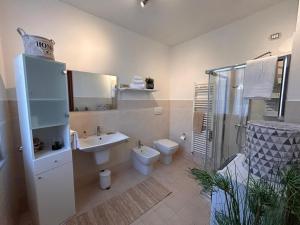 a bathroom with a toilet and a sink and a shower at Residenza dell'Arco in Gambolò