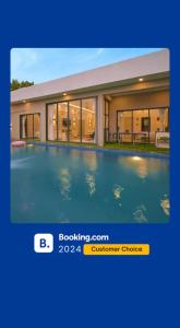 a picture of a house with a swimming pool at EKOSTAY Luxe - Ivory Coast Villa in Alibaug