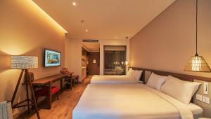 Ein Bett oder Betten in einem Zimmer der Unterkunft Apec Mandala Ocean Retreat - Mui Ne