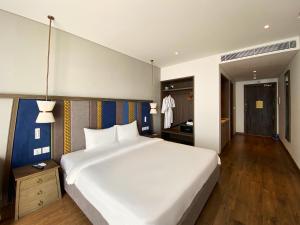 Ein Bett oder Betten in einem Zimmer der Unterkunft Apec Mandala Ocean Retreat - Mui Ne