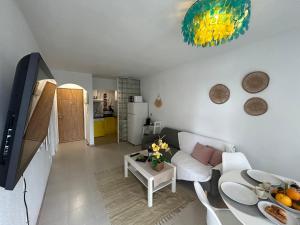 a living room with a white couch and a table at Hernando II in Calpe +10 photos