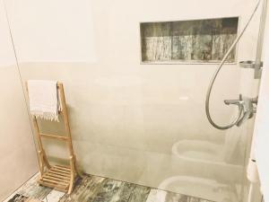 a bathroom with a shower with a glass door at Capital Apartment Tirana in Tirana +45 photos