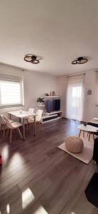 a living room with a table and chairs and a television at Casa Bruno in Vodnjan