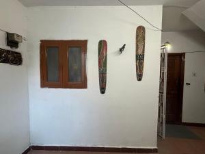 a wall with two surfboards hanging on a wall at Hostel Madras in Chennai