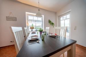 a dining room with a wooden table and chairs at Aurora#1 mit großem Garten, Sauna und Kamin in Wiesmoor