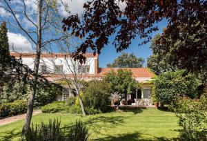 an exterior view of a house with a yard at The Escorial House in Escorial