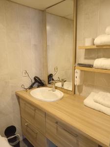 a bathroom with a sink and a mirror and towels at Hanzade Turizm in Istanbul