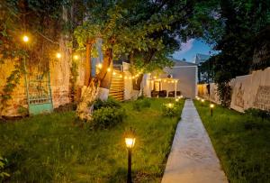 a garden at night with lights in the grass w obiekcie High Ceilings Apartments Bucharest GARDEN - Parking w Bukareszcie