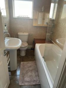 a bathroom with a sink and a toilet and a tub at Aldam House in Darlington +12 photos