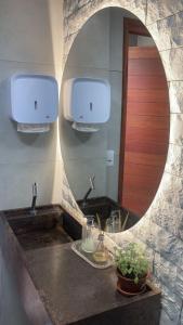 a bathroom with a sink and a mirror at Hotel Gogó da Ema in Maceió +32 photos