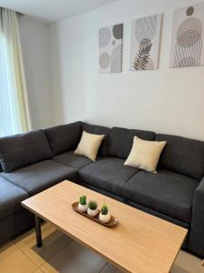 a living room with a couch and a coffee table at Cozy apartment with swimming pool in Lloret de Mar